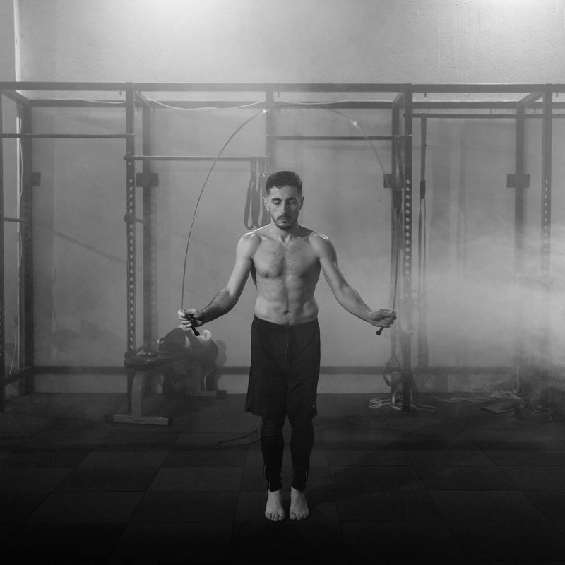 A large central image showing a man mid-exercise with intense focus.